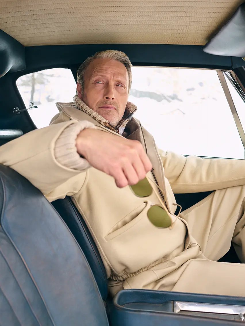 Mads Mikkelsen wearing a ZEGNA winter look featuring a ski suit.