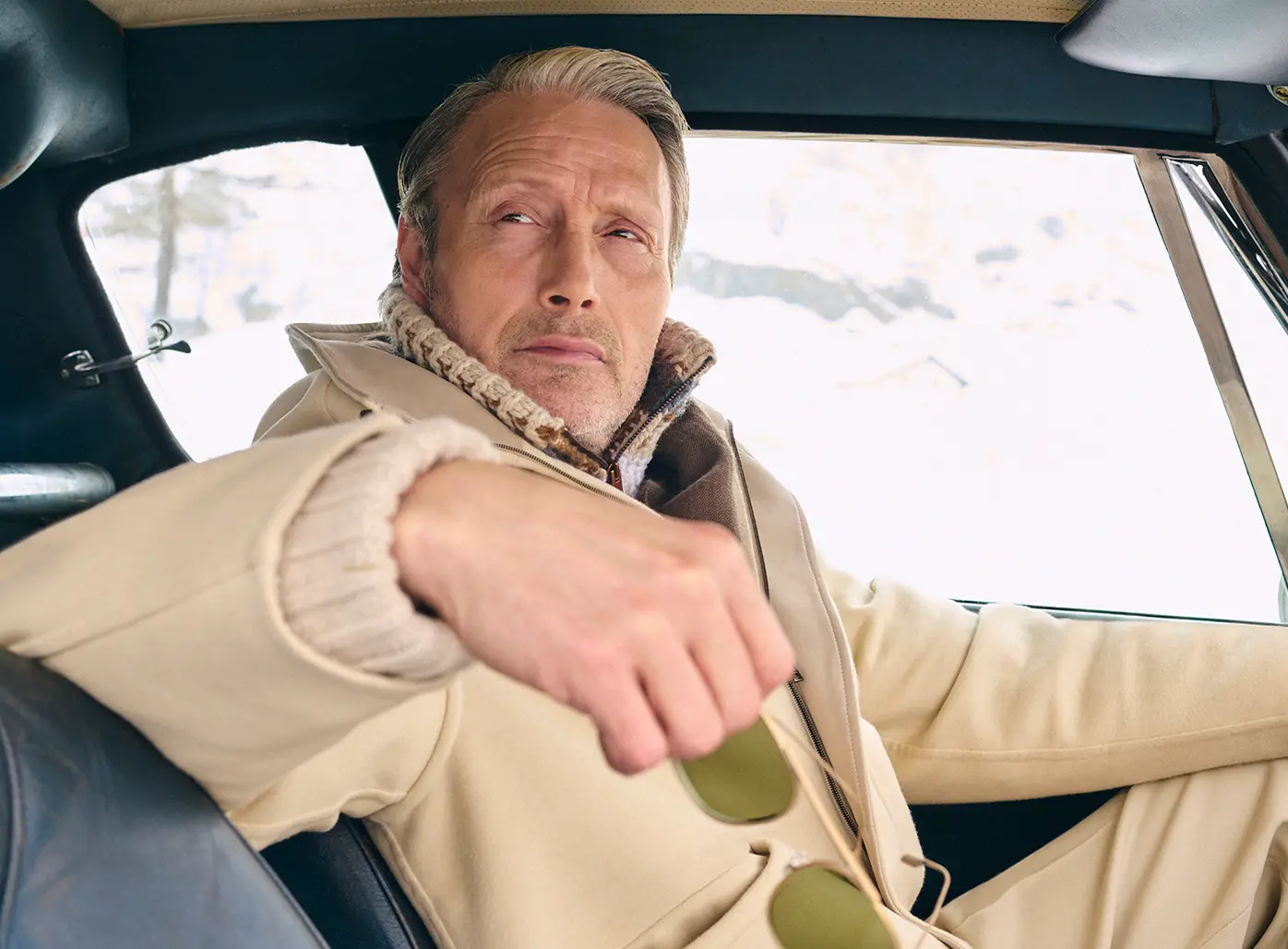 Mads Mikkelsen wearing a ZEGNA winter look featuring a ski suit.