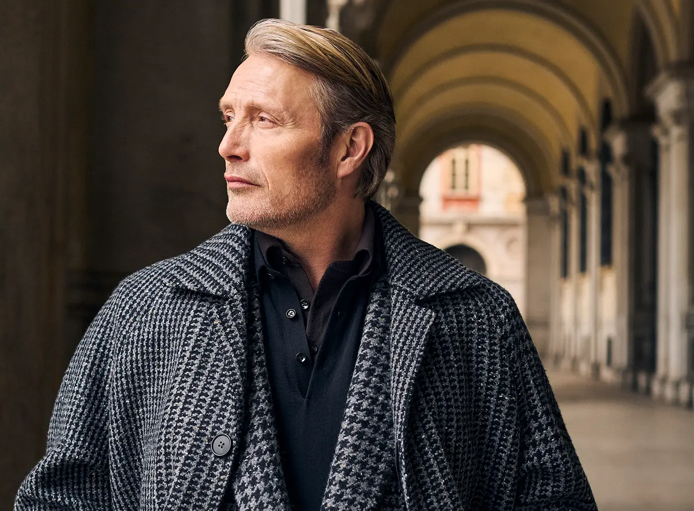 Mads Mikkelsen wearing a ZEGNA winter look featuring a ski suit.