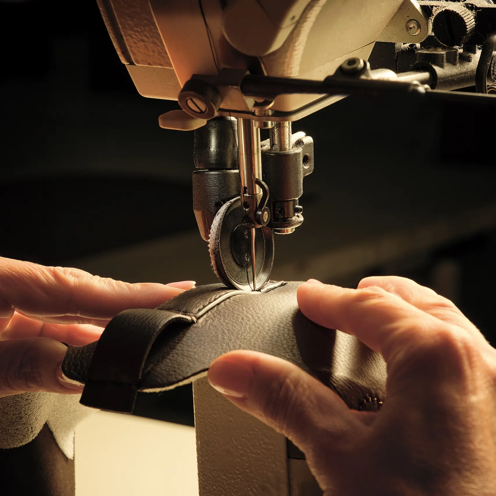 Image of a ZEGNA artisan sewing together pieces of leather to create Triple Stitch™ SECONDSKIN sneakers.