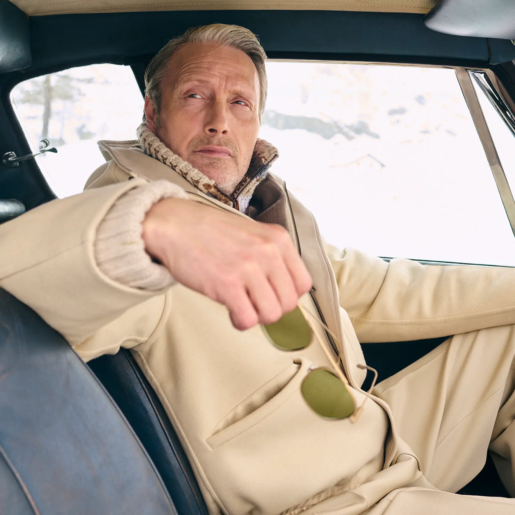 Mads Mikkelsen wearing a ZEGNA winter look featuring a ski suit.