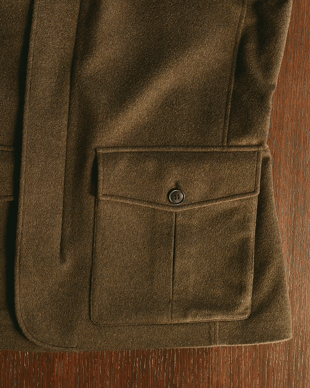 Detail of the bellows pocket with button closure of the Oasi Cashmere Falcon Jacket in brown, ZEGNA Fall/Winter 2026 collection.