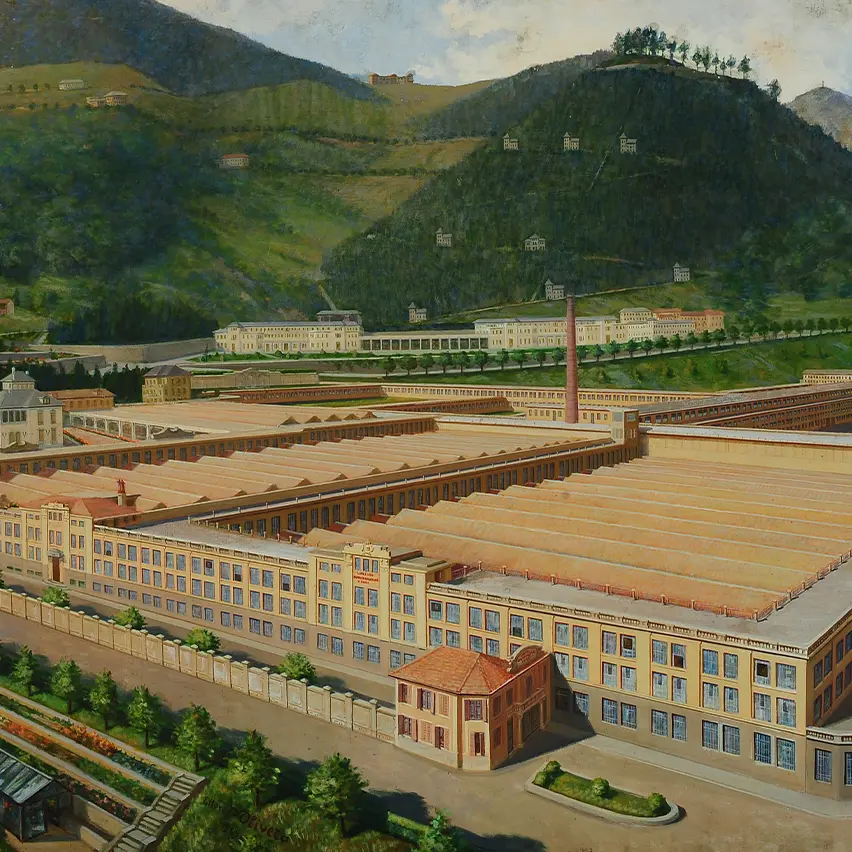 A detailed painting depicting the Lanificio Ermenegildo Zegna factory complex set against a backdrop of green hills and a partly cloudy sky.