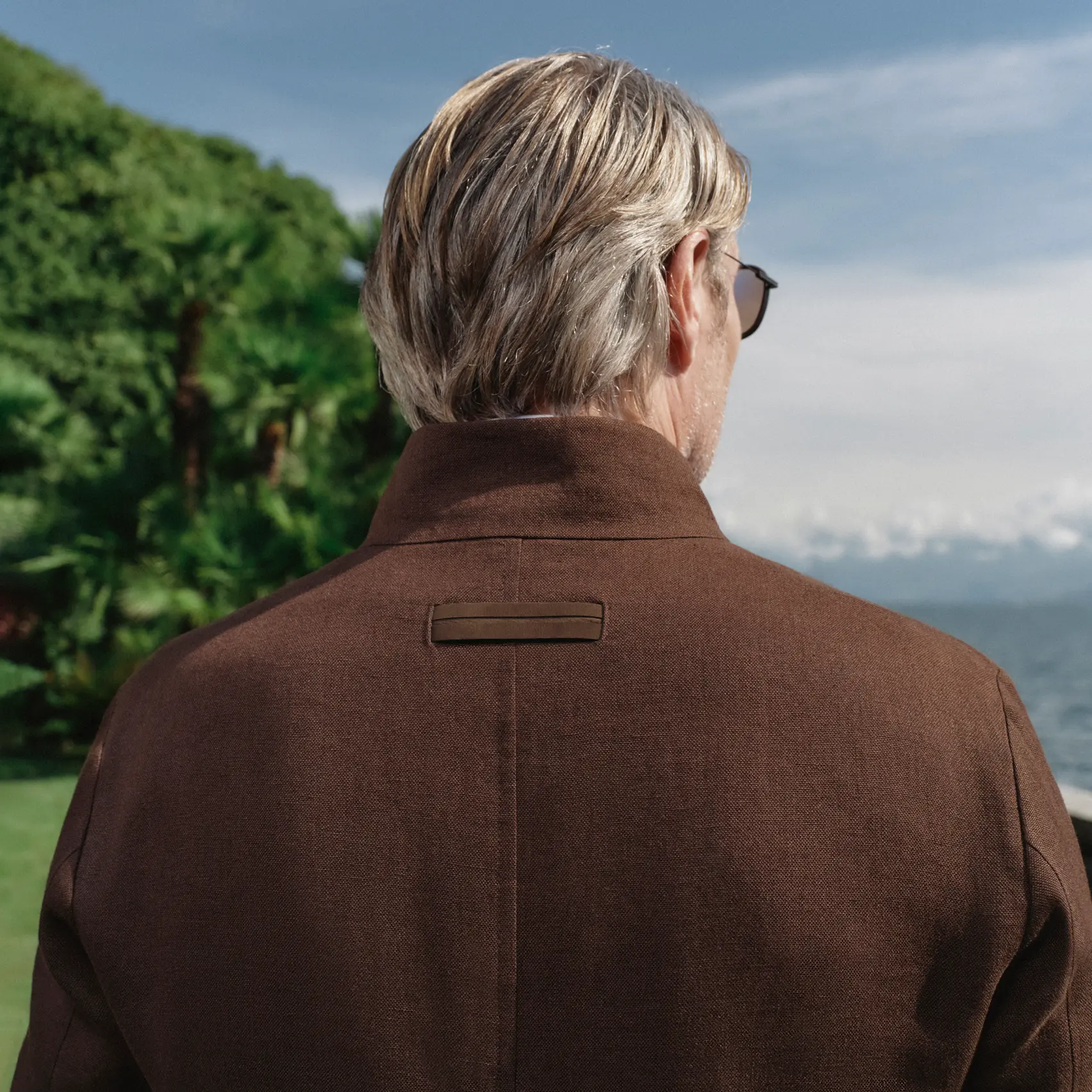 Back view of Mads Mikkelsen with close-up detail of ZEGNA jacket from the Spring Summer 2026 collection.