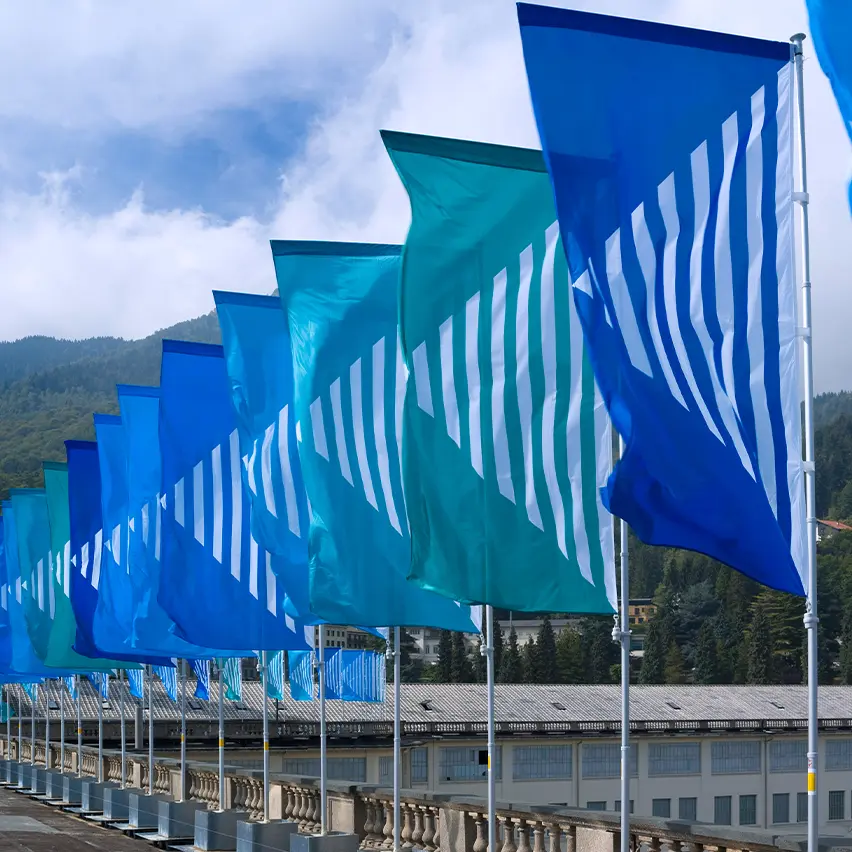 Outdoor installation of colorful wind vanes by Daniel Buren at Lanificio Zegna.