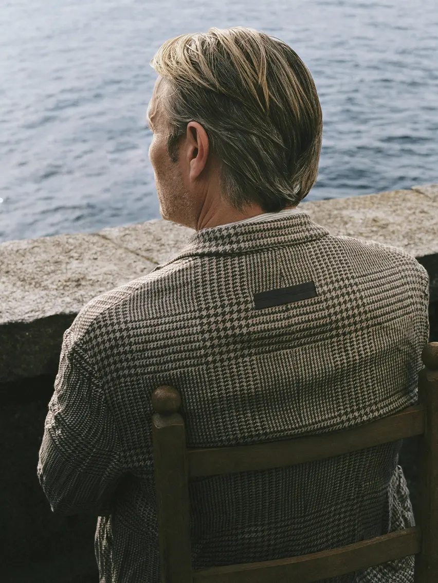 Mads Mikkelsen wearing an elegant ZEGNA Spring Summer 2026 look featuring linen trousers and a linen jacket.
