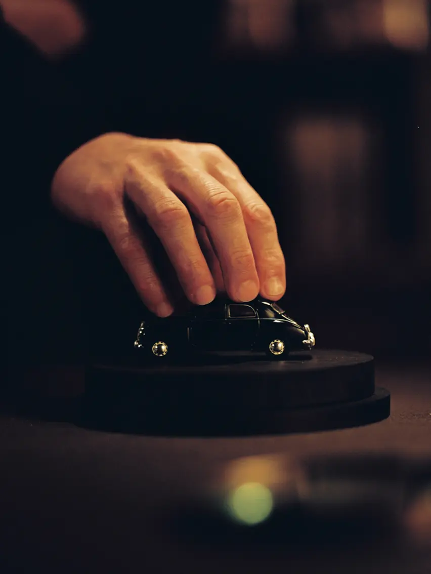 Close-up of a black car scale model, highlighting sleek lines and a refined, understated aesthetic.