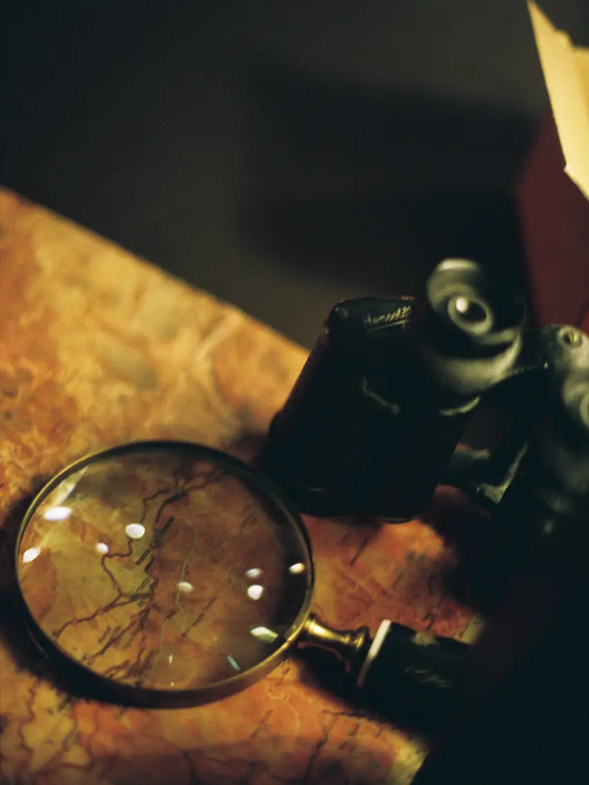 Close-up of objects evoking travel and exploration, suggesting a sense of journey, perspective, and discovery.