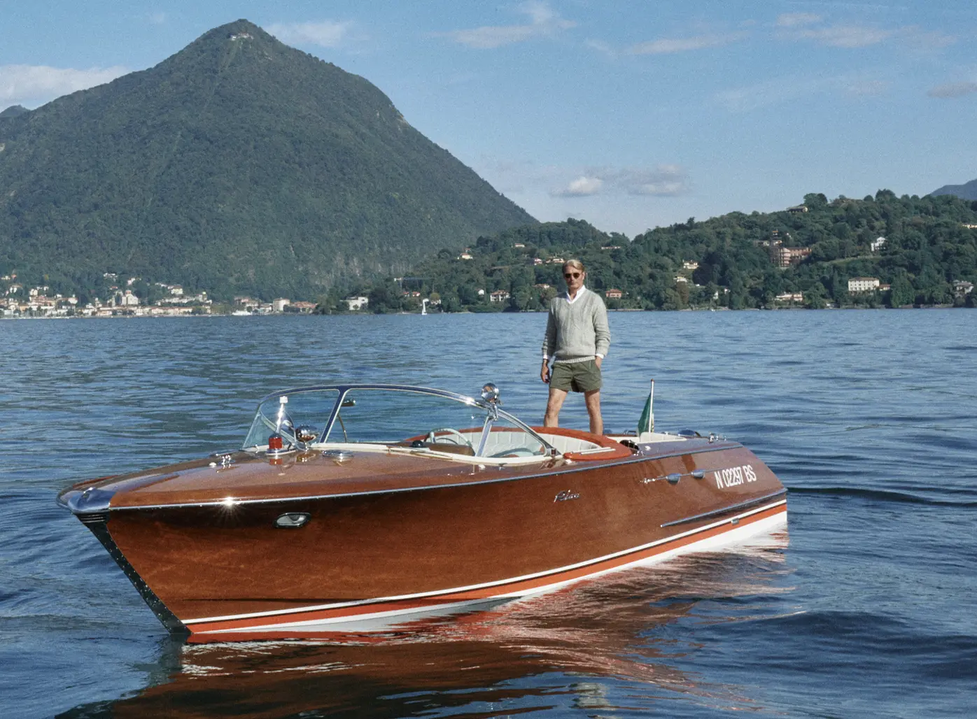Mads Mikkelsen on a boat wearing a ZEGNA Spring Summer 2026 look featuring a V-neck sweater and the iconic Rio beachwear.