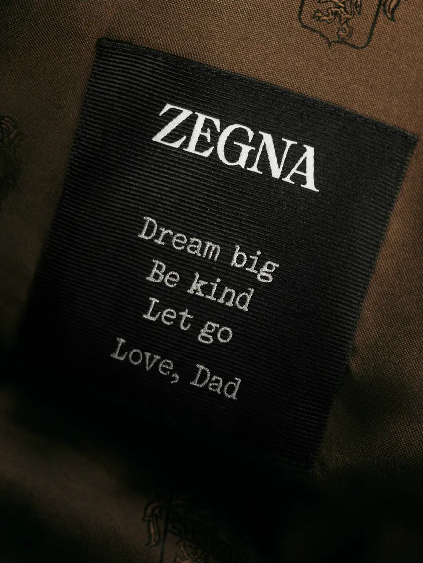 Close up of a ZEGNA garment label with a personal message.