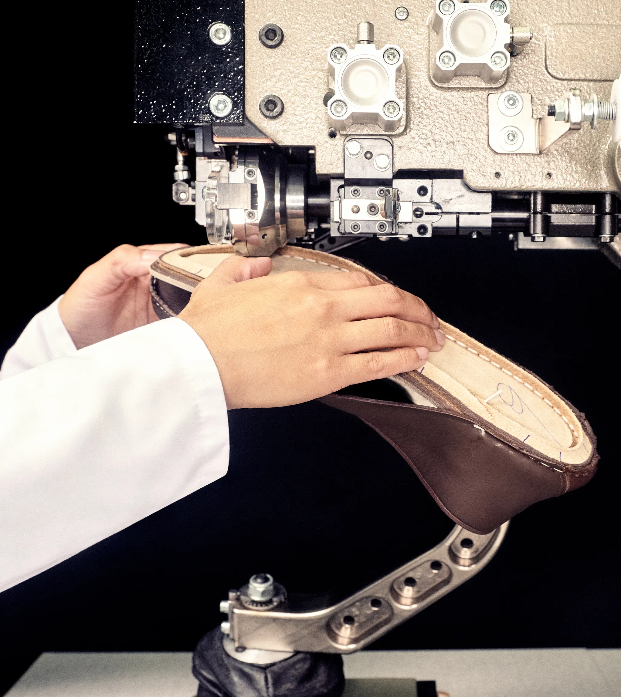 Artisan stitching the sole of a ZEGNA Mocassin using precision craftsmanship.