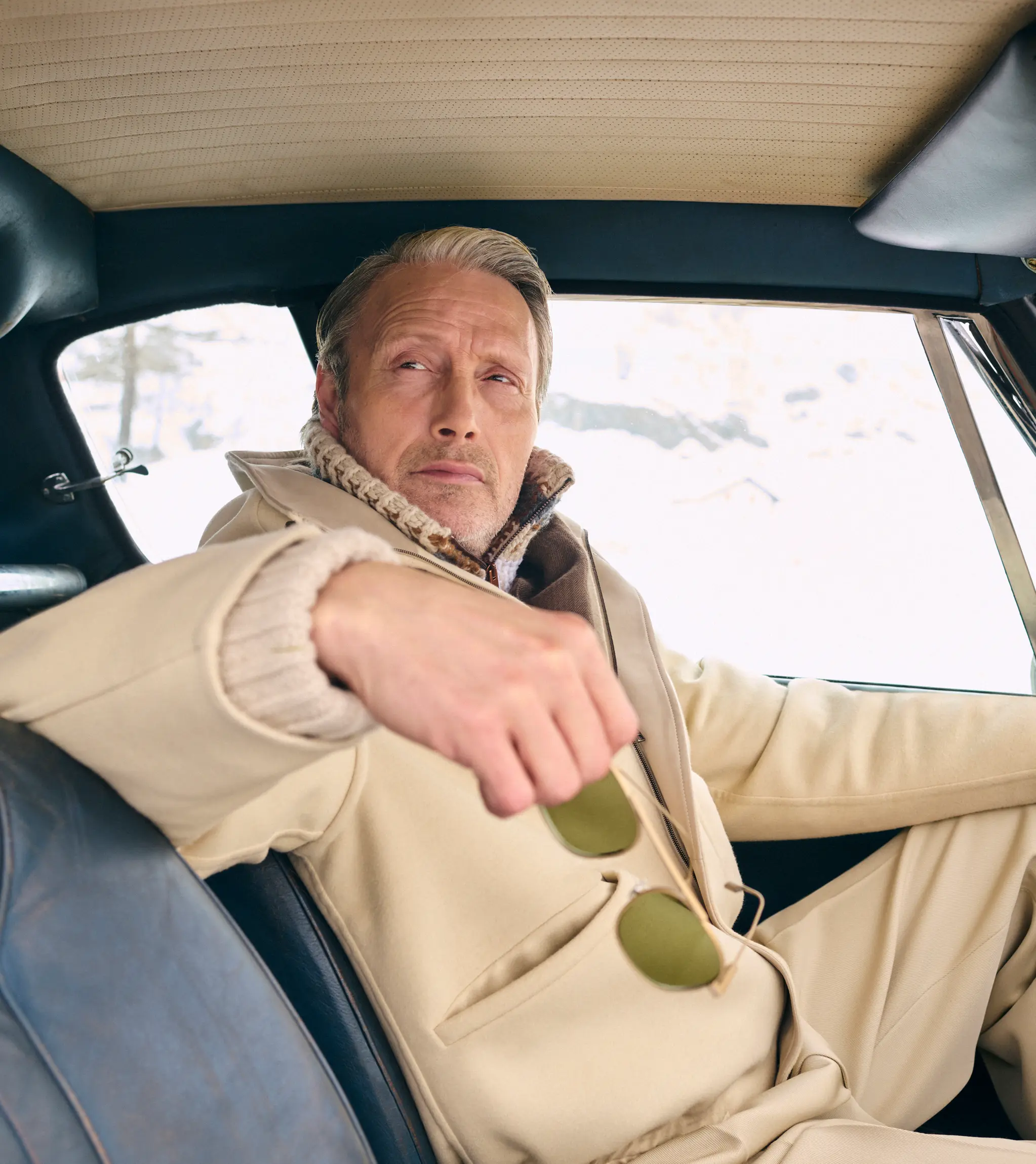 Mads Mikkelsen wearing a ZEGNA winter look featuring a ski suit.