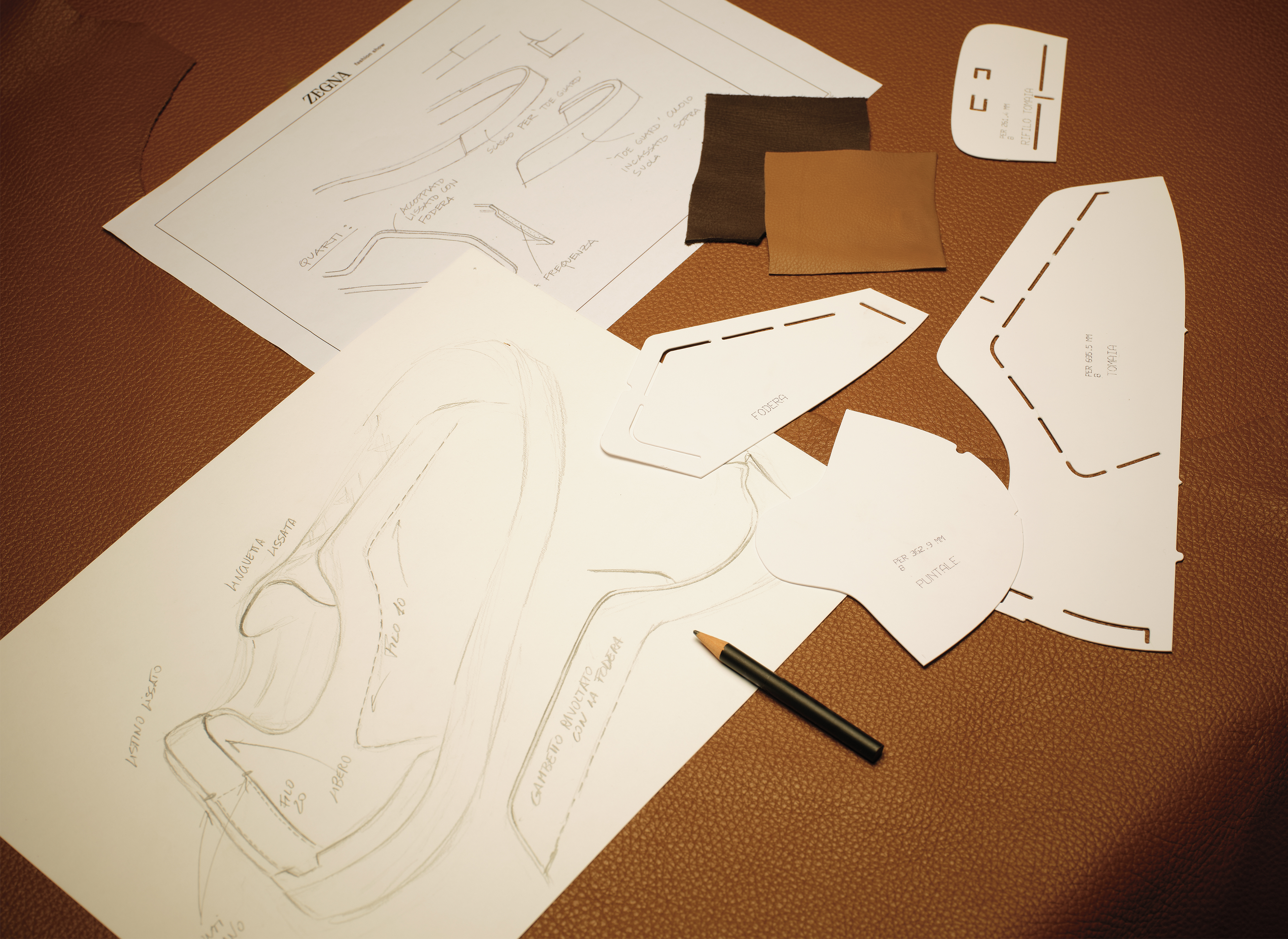 Sketches of Triple Stitch™ Sneakers displayed in a ZEGNA laboratory.