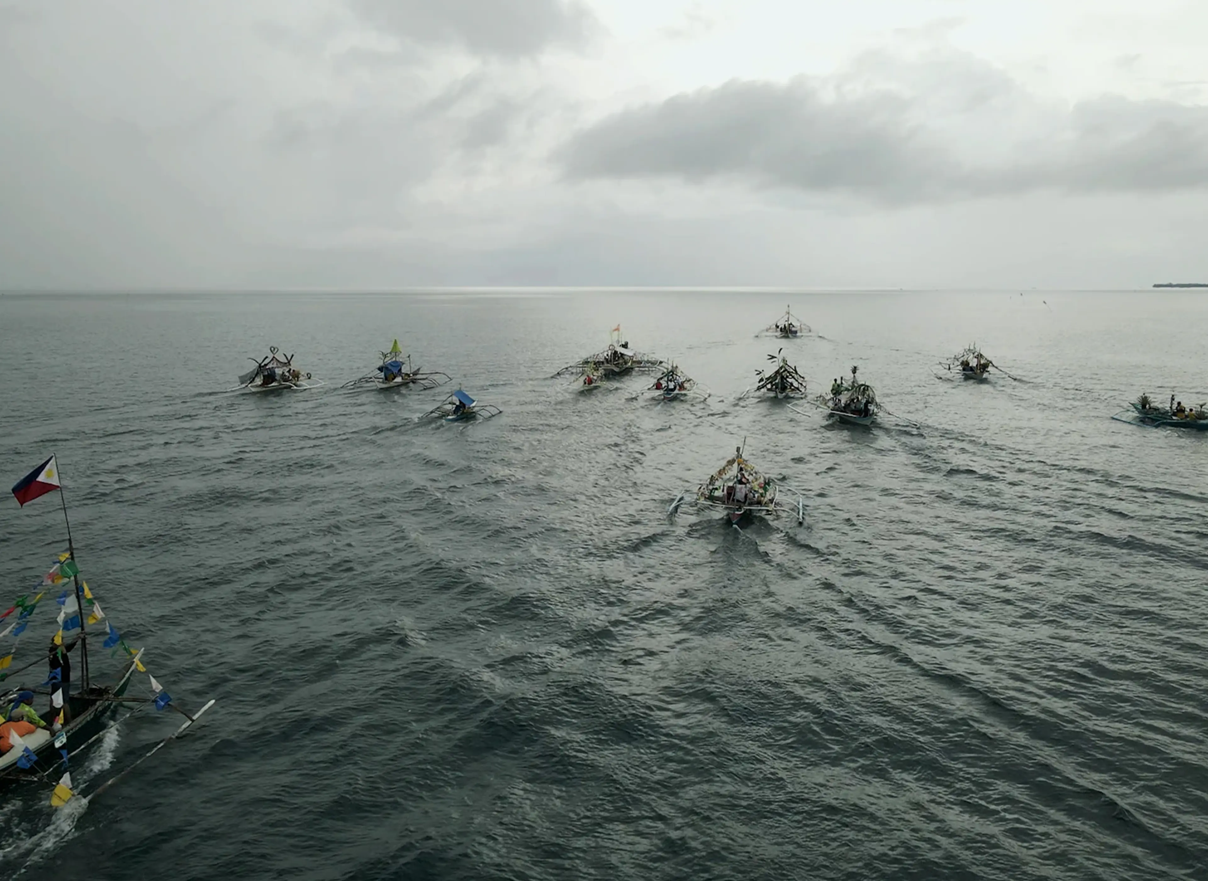 Fisherfolk, an artwork featuring a traditional fishing boat decorated with plastic waste to highlight ocean pollution.