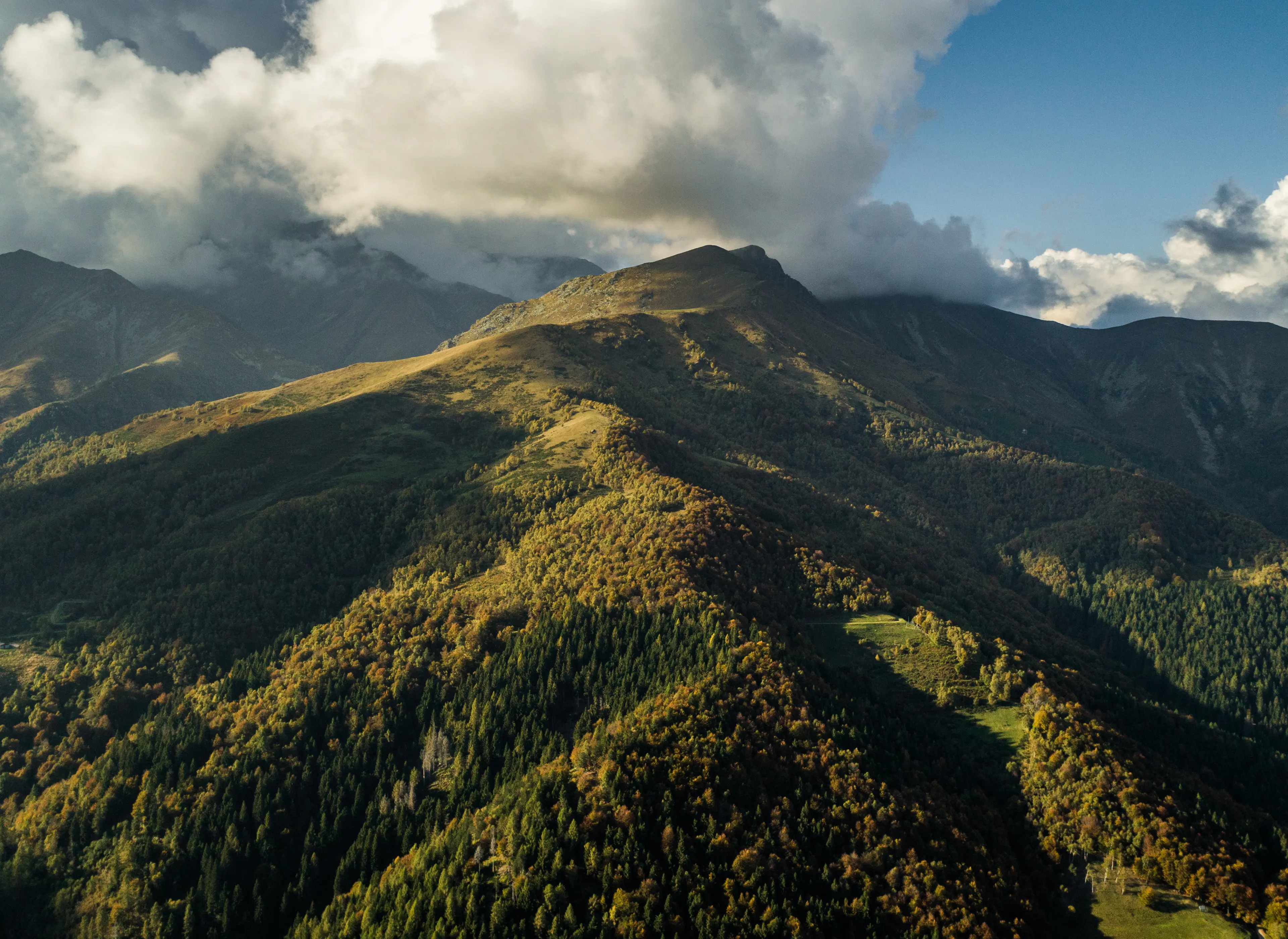 Aerial view of Oasi Zegna with green landscapes, forested hills, and natural park scenery..