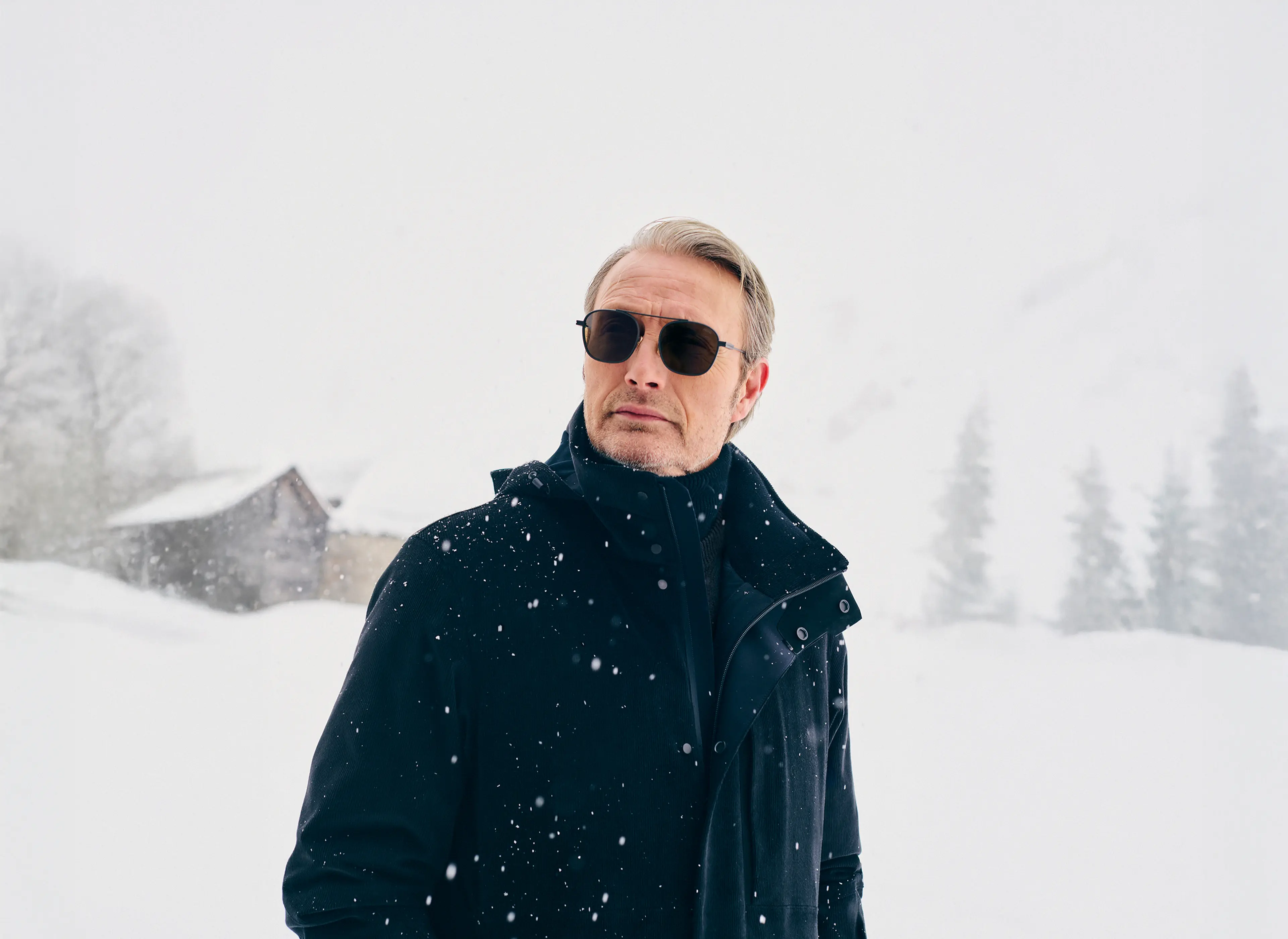 Mads Mikkelsen wearing a ZEGNA winter look featuring a ski suit.