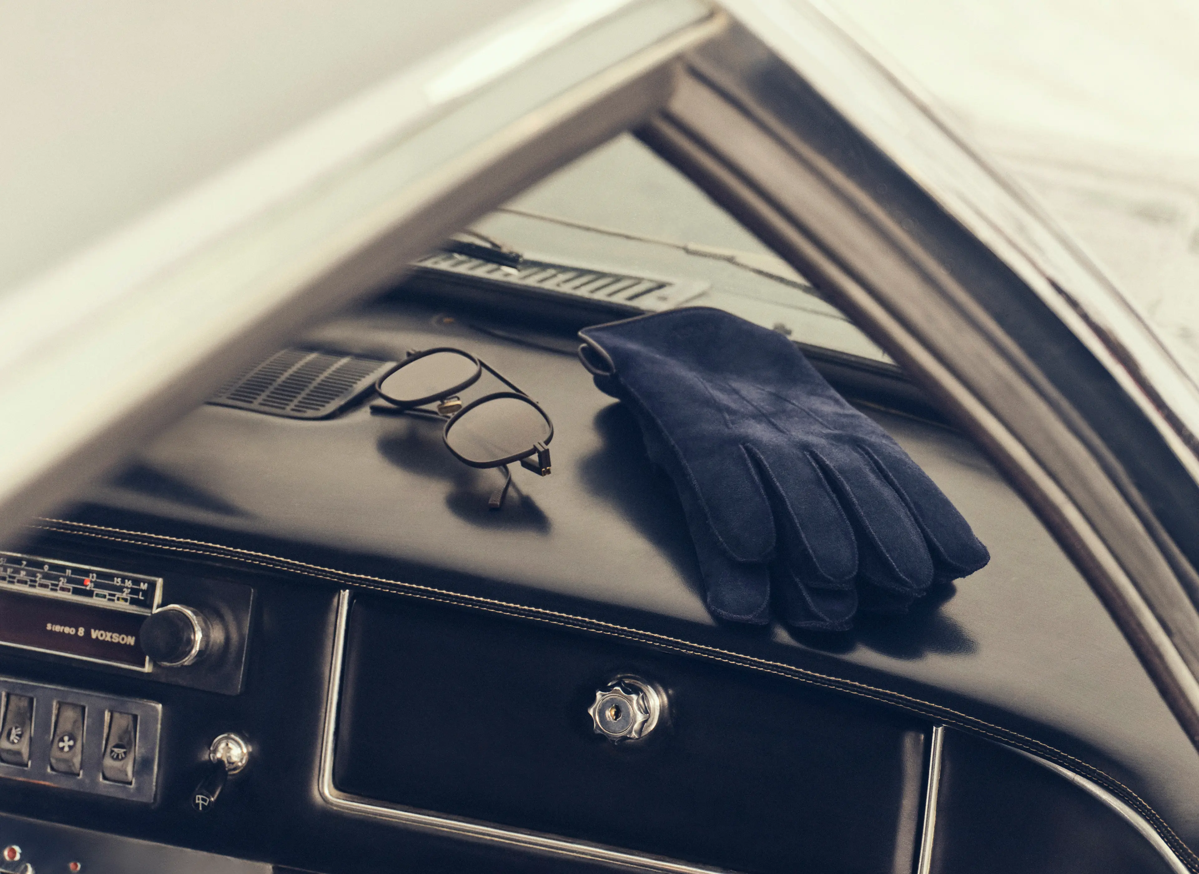 Close-up of ZEGNA gloves inside a sports car, Fall Winter 2025 collection.