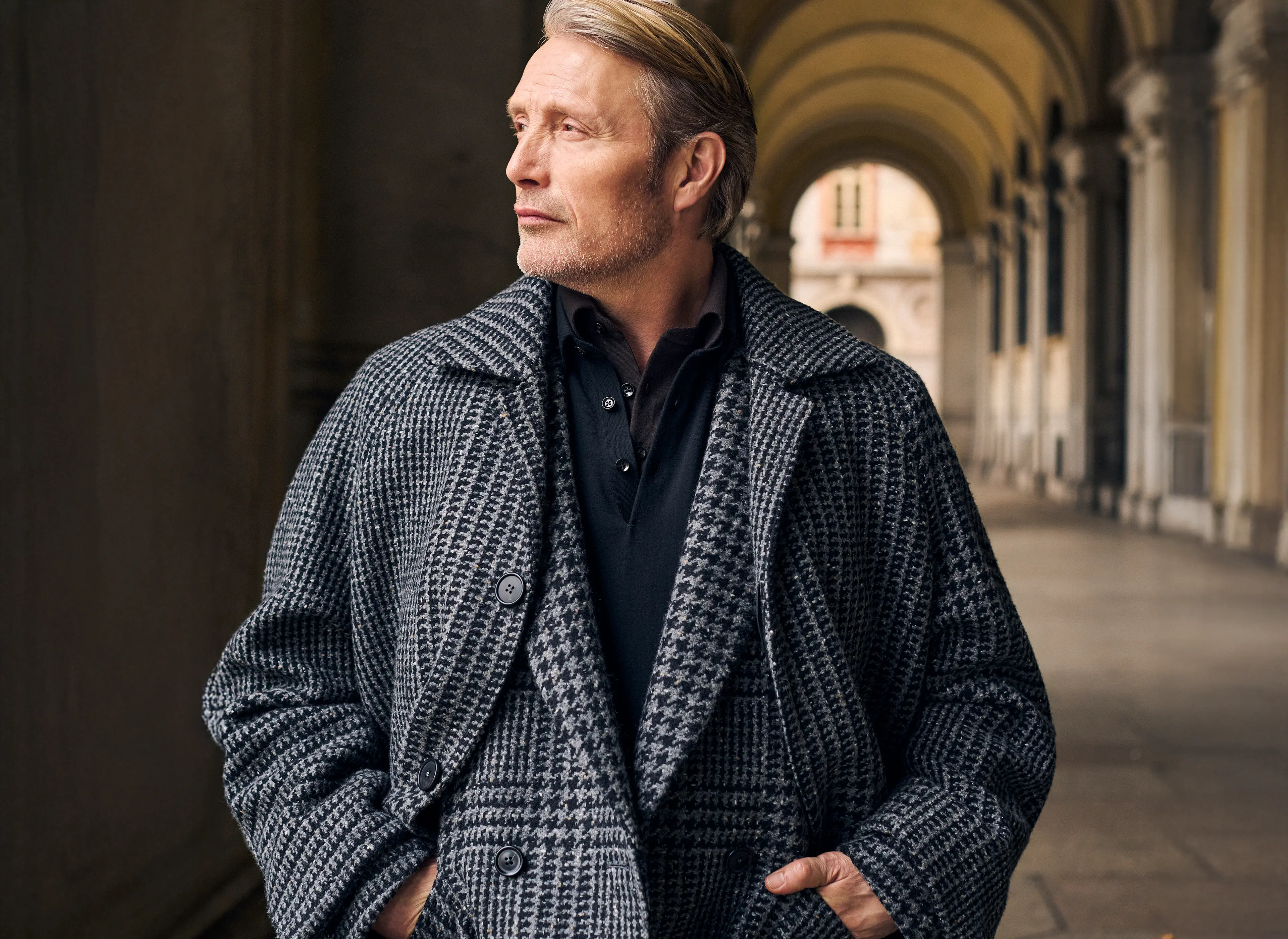 Mads Mikkelsen wearing a coordinated houndstooth coat and suit in Torino style, from the ZEGNA FW25 collection.