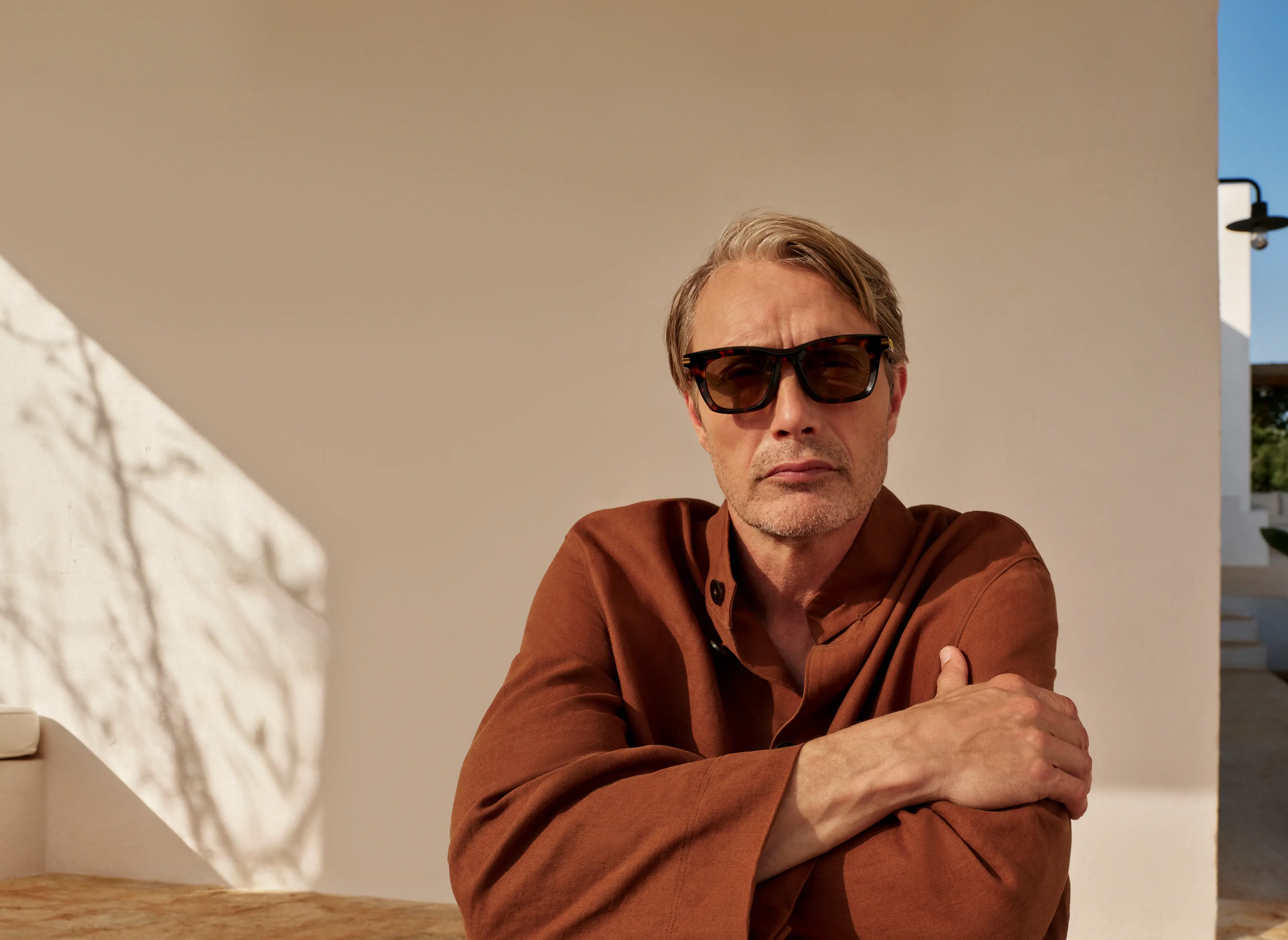 Mads Mikkelsen wearing acetate sunglasses and a shirt from the ZEGNA Spring/Summer 2025 collection.