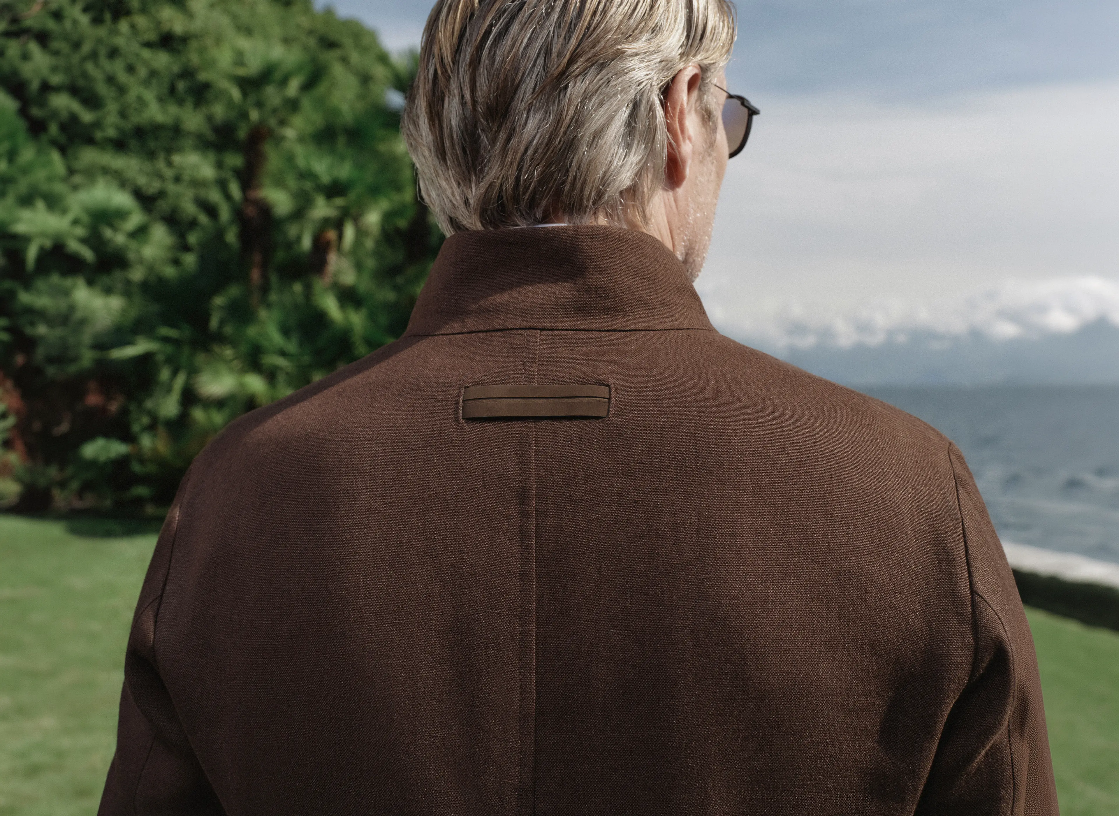 Back view of Mads Mikkelsen with close-up detail of ZEGNA jacket from the Spring Summer 2026 collection.