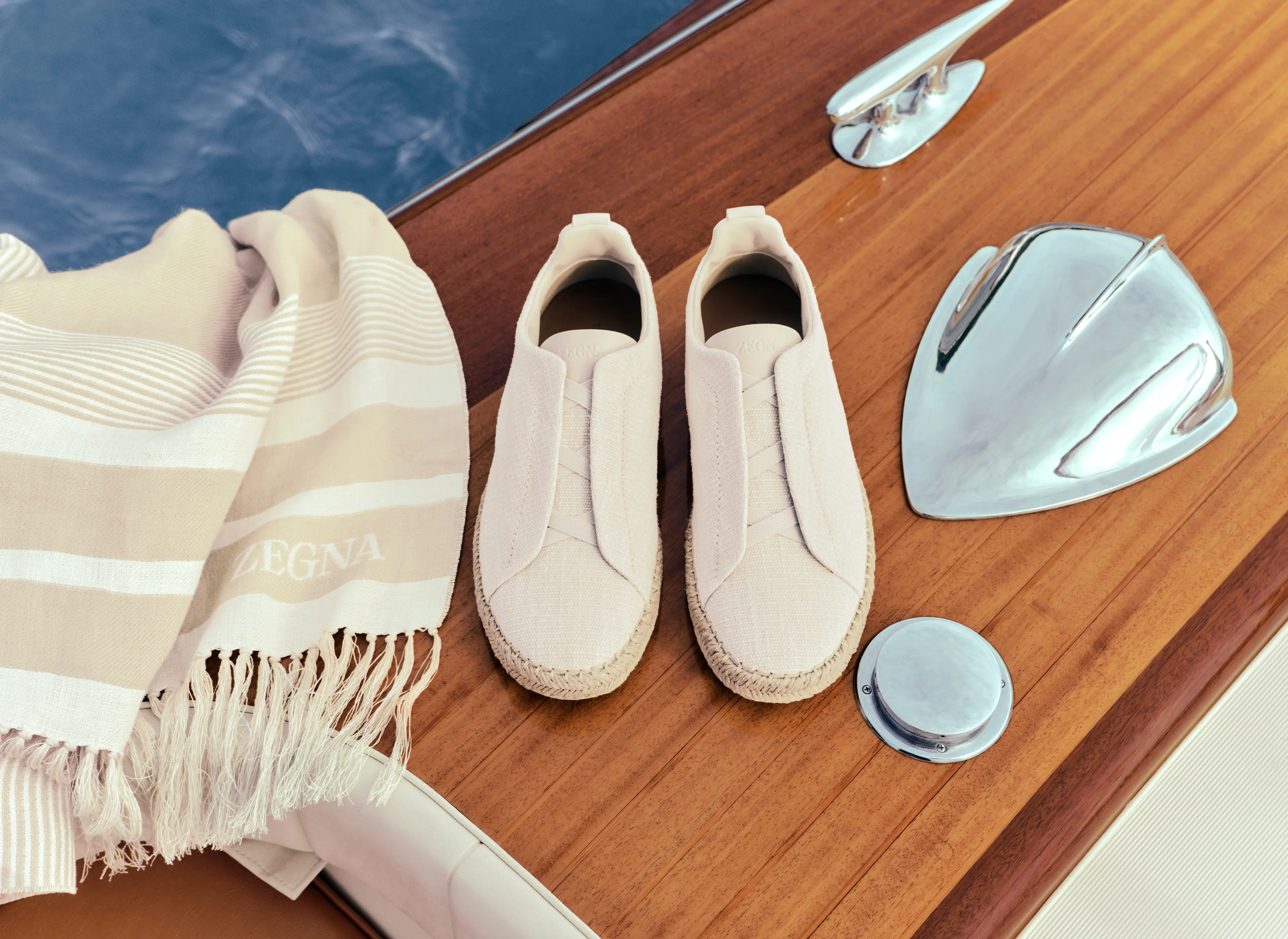 ZEGNA Triple Stitch linen espadrillas and beach towel from the Spring Summer 2026 collection with boat background.