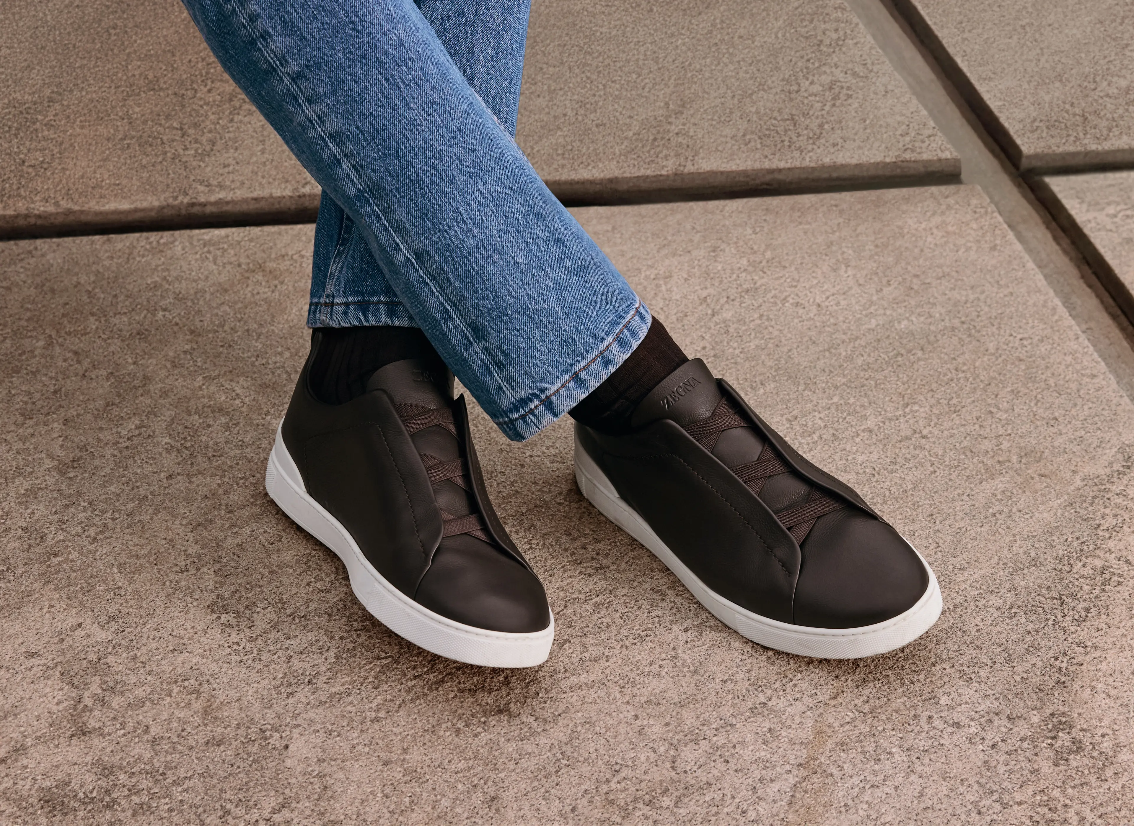 Man wearing luxury Triple Stitch™ sneakers with denim, from the ZEGNA Fall/Winter 2025 collection.