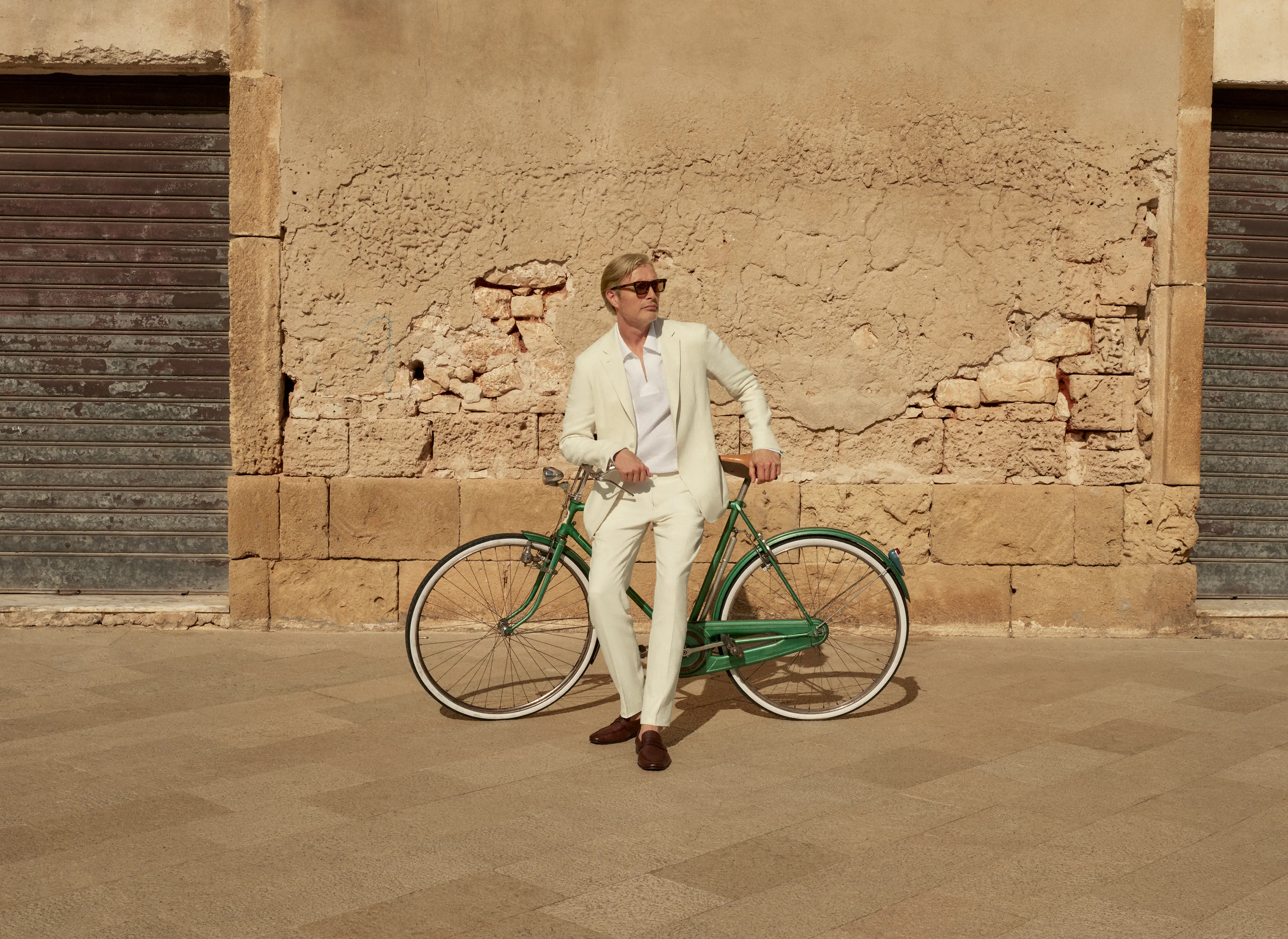 Mads Mikkelsen wearing a tailored linen suit and leather loafers from the ZEGNA Spring/Summer 2025 collection.