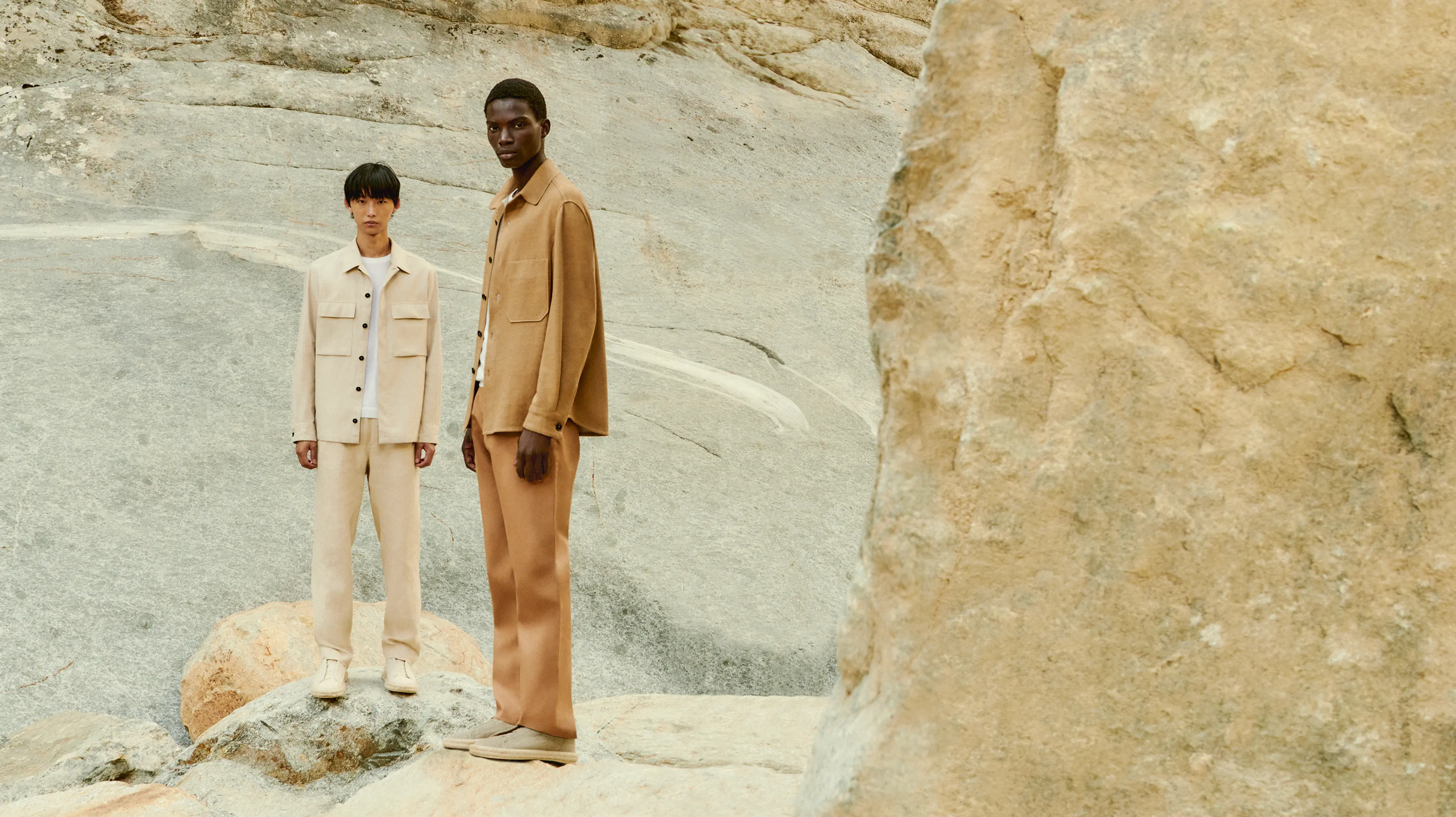 Two men wearing business casual outfits from the Luxury Leisurewear collection designed by ZEGNA with beige overshirts.