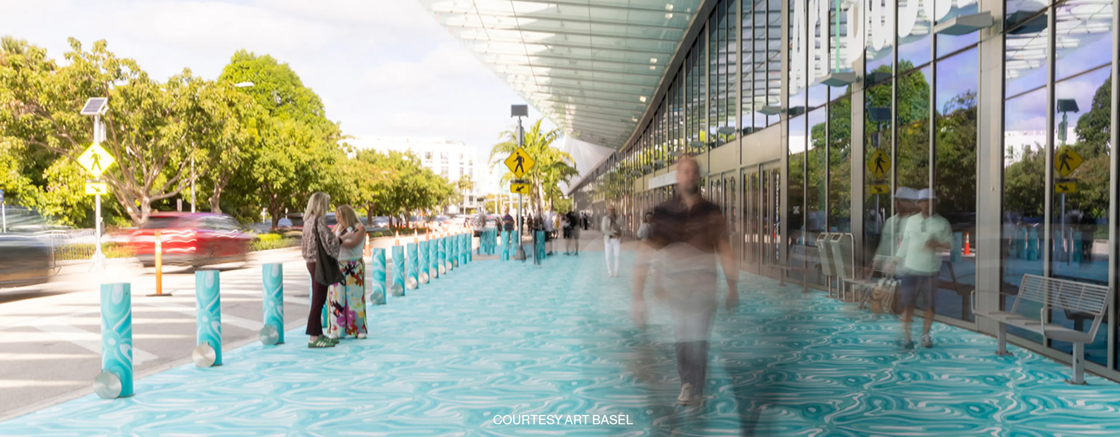 Exterior view of the Miami Beach Convention Center surrounded by palm trees.