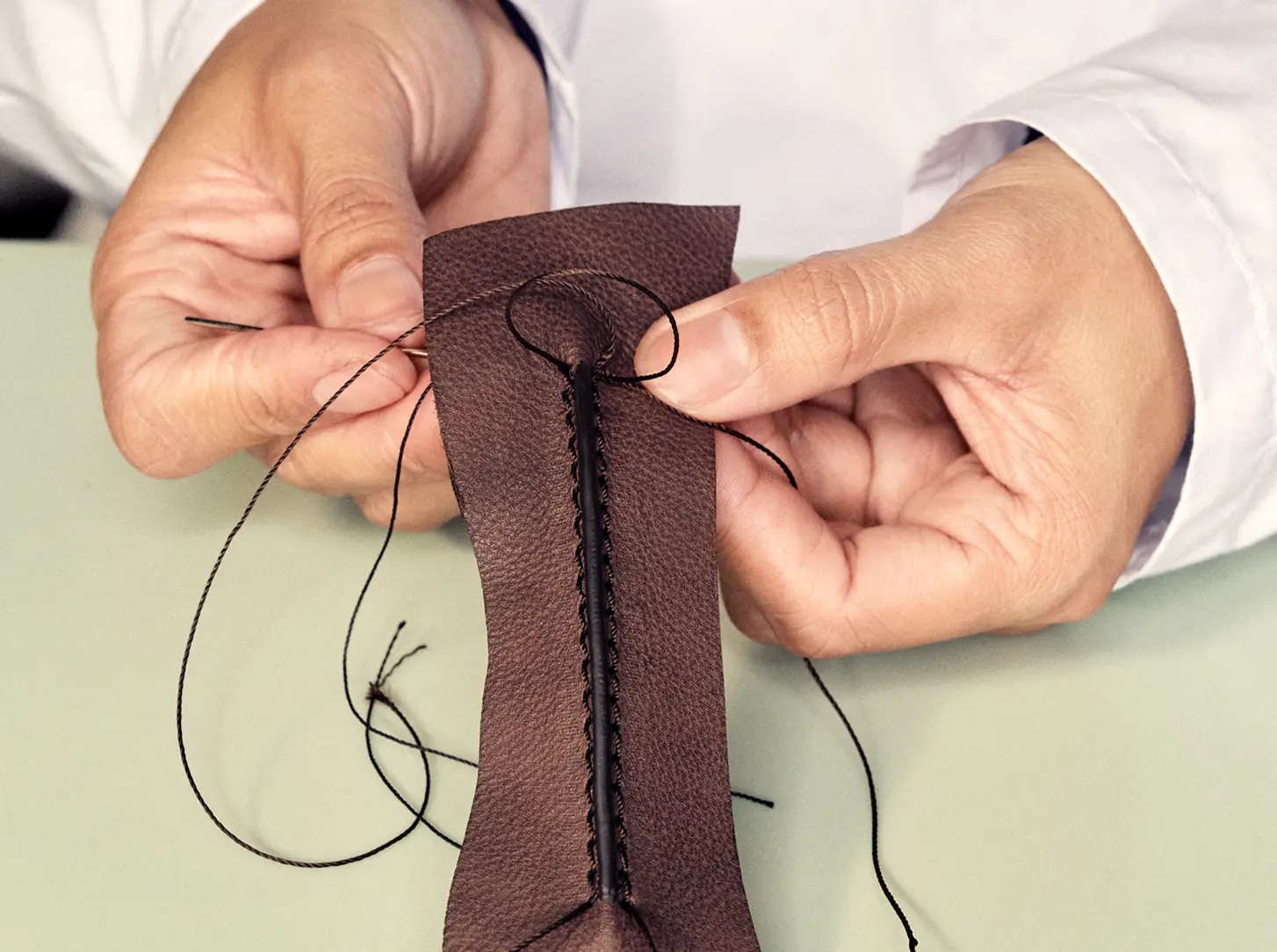 Artisan hand-stitching fine leather for ZEGNA's Mocassin.
