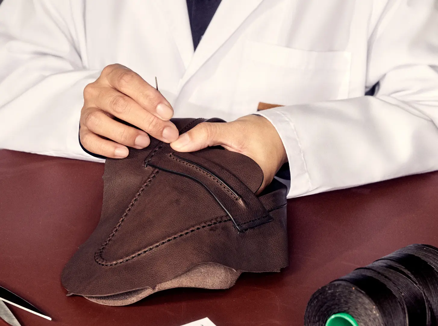 Artisan hand-stitching fine leather for ZEGNA's Mocassin.
